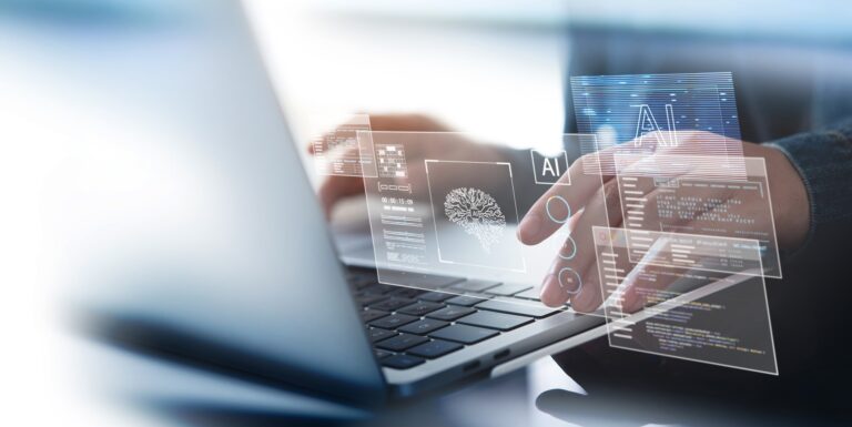 A man typing on a laptop while AI graphics float above it.