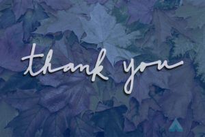 Handwritten thank you on an autumn leaf background