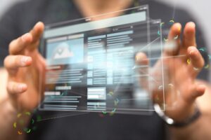 A person holds a holographic representation of a browser window in the air using his finger tips.