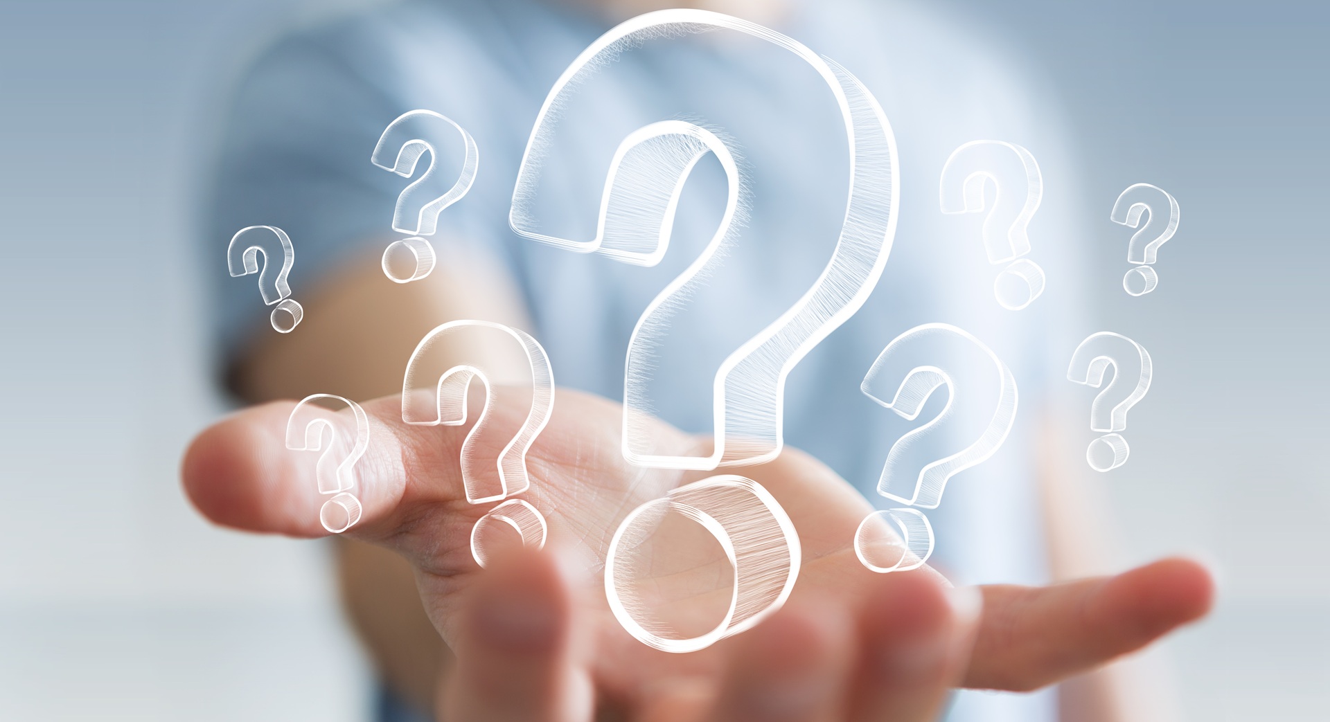 An outreached hand with its palm up with floating question mark graphics above it.